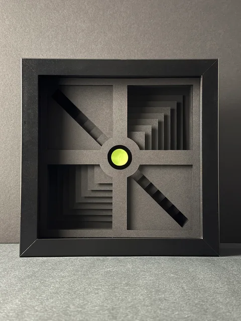 NF-01. Front view of the framed paper relief, with four stepped recesses and a lime circular center.