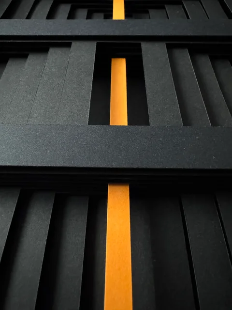 NF-03. Low close-up looking along the vertical orange core through the paper openings.