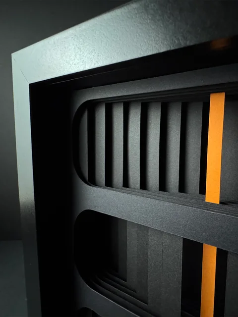 NF-03. Side close-up of a rounded opening, recessed paper layers, and the orange core.
